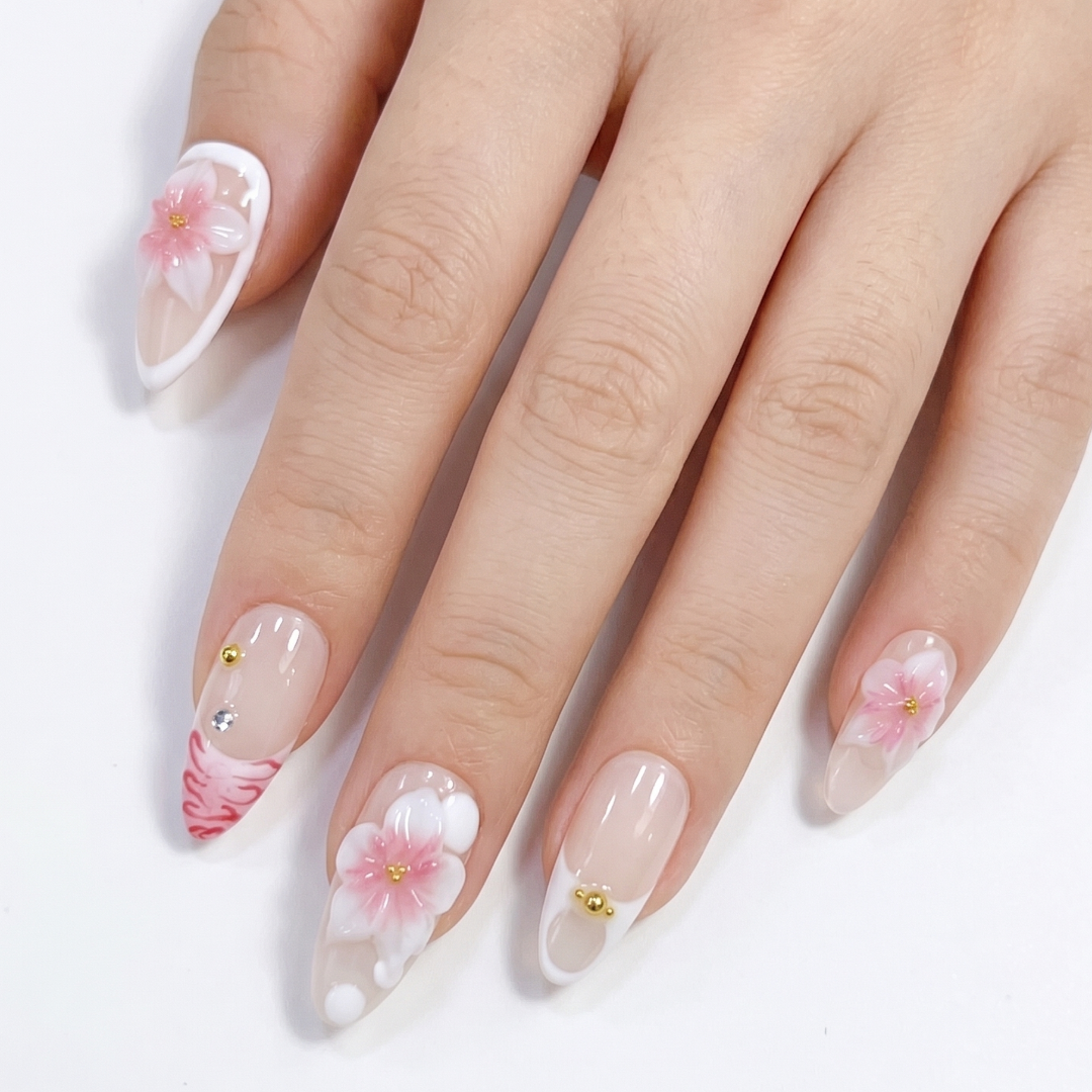 Hand with floral nail art on a white background