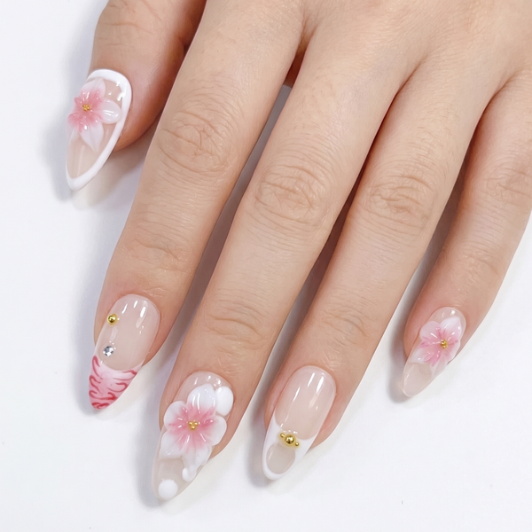 Hand with floral nail art on a white background