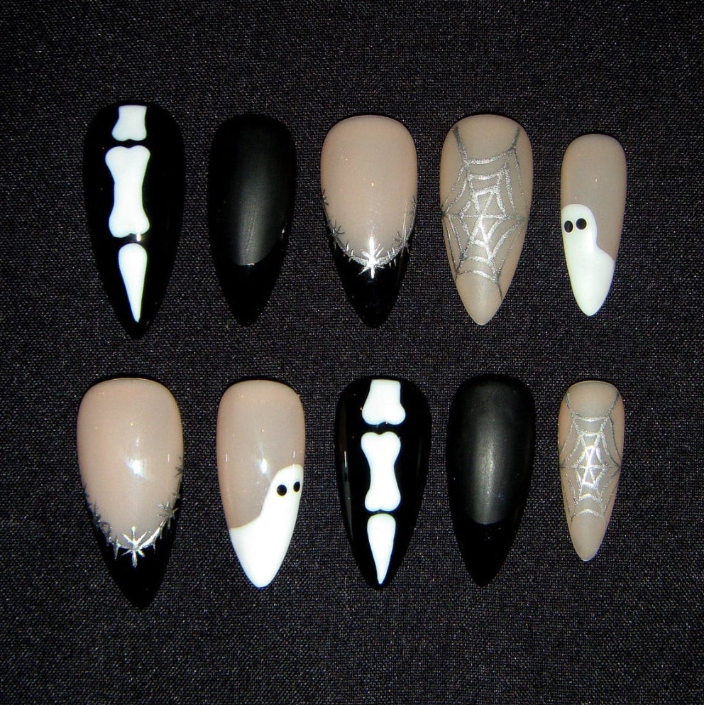 Set of Halloween-themed nail art designs on a black background