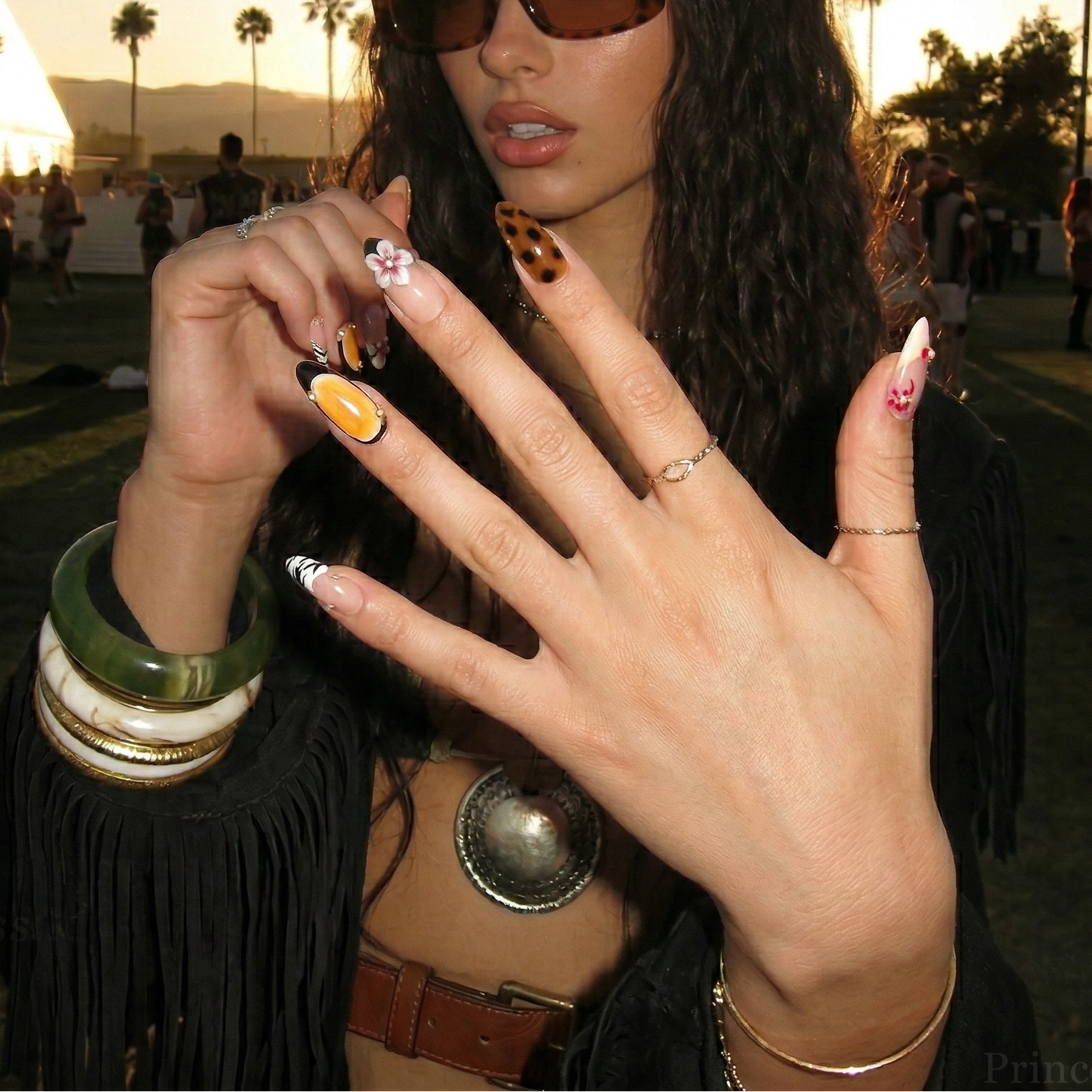 Woman with stylish nail art and accessories in a casual setting
