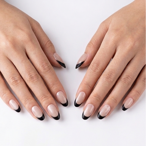 Close-up of two hands with black and white nail polish on a white background