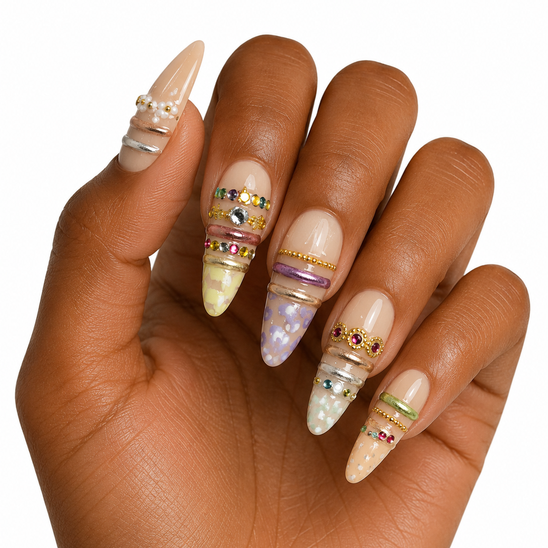 Hand with decorated nails featuring gemstones on a white background
