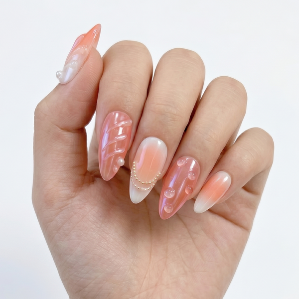 Hand with pink and white nail art on a plain background