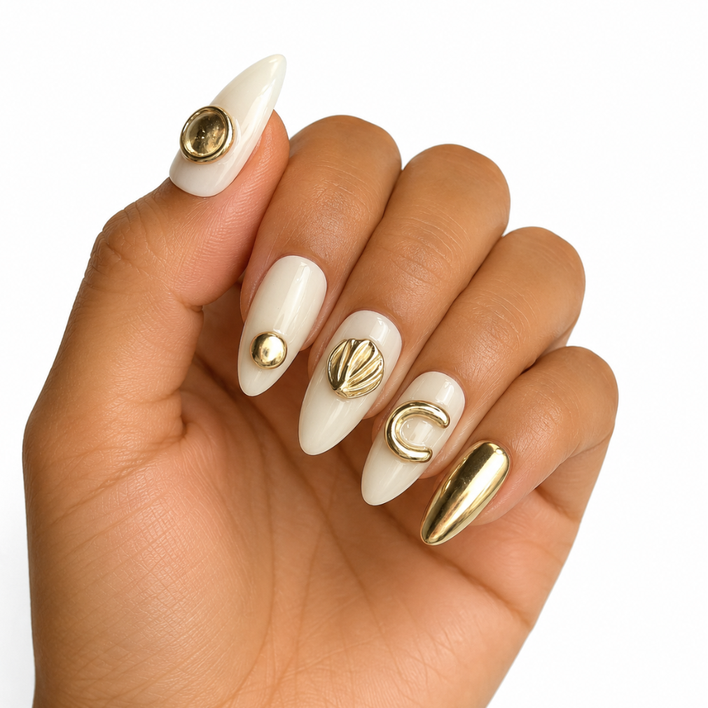 Hand with white and gold nail art on a white background