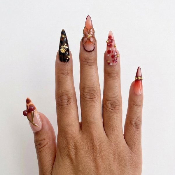 Hand with long, intricately designed nails on a white background