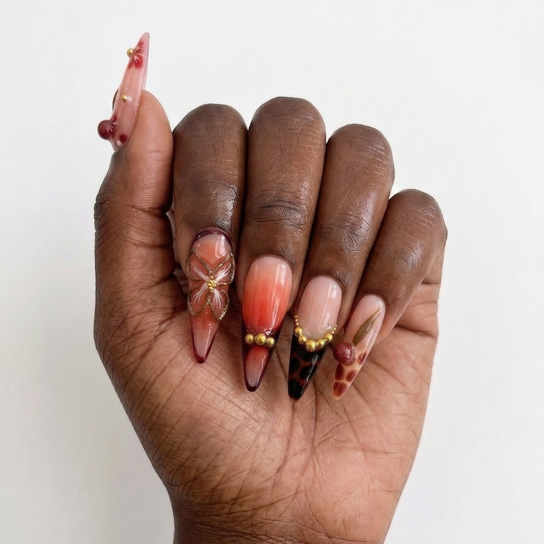 Hand with intricately designed nails on a white background