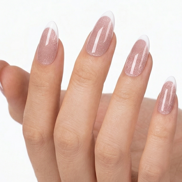 Close-up of a hand with pink nail polish on a white background